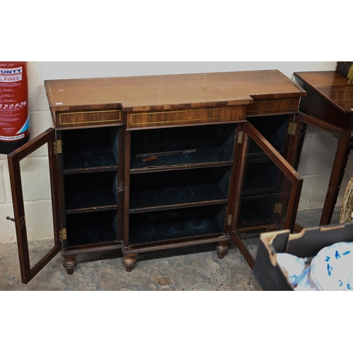 118 - A 19th century rosewood breakfront bookcase with glazed doors on short turned supports, decorative b... 