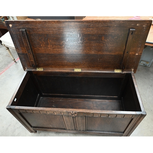 128 - A 20th century oak blanket chest/coffer, with a hinged top on panelled base with carved detail, 104 ... 