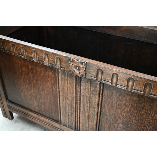 128 - A 20th century oak blanket chest/coffer, with a hinged top on panelled base with carved detail, 104 ... 