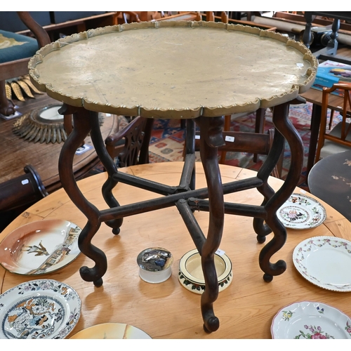 130 - An early 20th century Chinese occasional table, the scalloped engraved brass tray top resting on sta... 