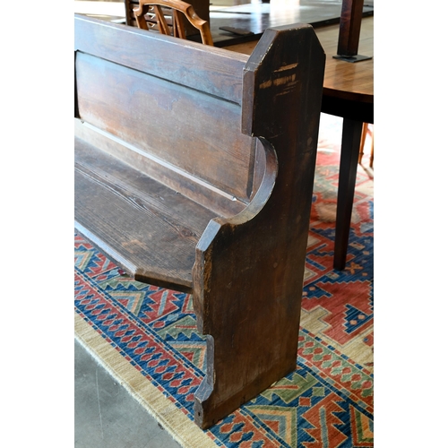 139 - An antique stained pine pew, 220 cm wide