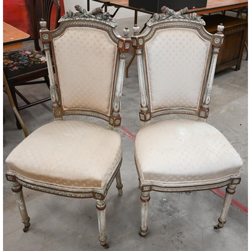 141 - A pair of painted and gilded carved French side chairs, on fluted front legs on casters