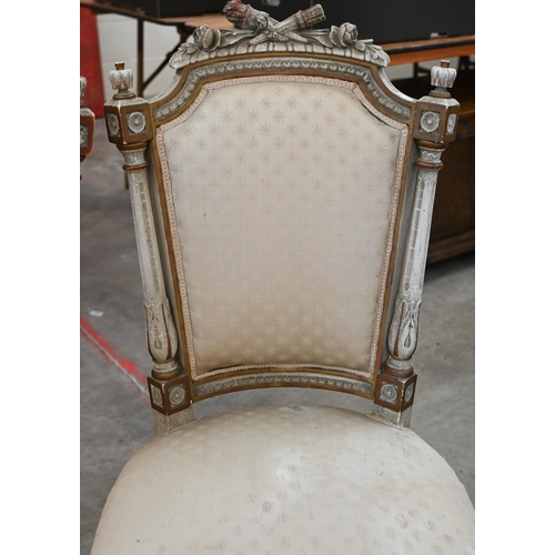 141 - A pair of painted and gilded carved French side chairs, on fluted front legs on casters