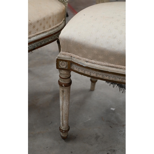 141 - A pair of painted and gilded carved French side chairs, on fluted front legs on casters