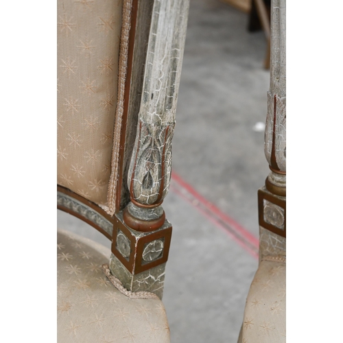 141 - A pair of painted and gilded carved French side chairs, on fluted front legs on casters