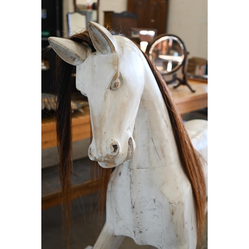 144 - A painted wooden rocking horse on swing stand with turned supports, 140 cm wide x 124 cm high