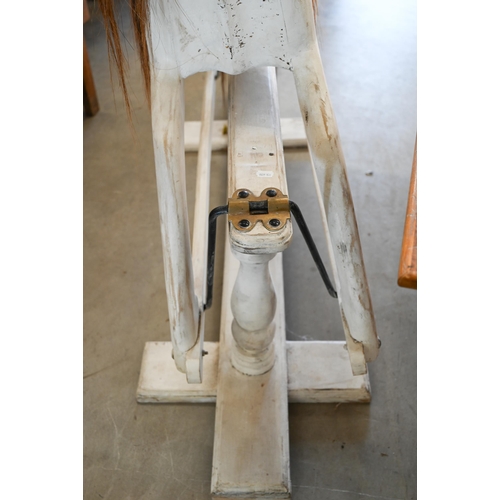 144 - A painted wooden rocking horse on swing stand with turned supports, 140 cm wide x 124 cm high