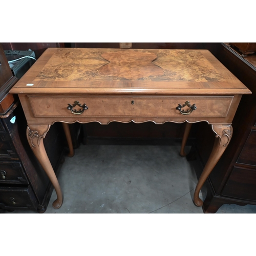 15 - A reproduction walnut side table with frieze drawer and cabriole supports with pad feet, 92 x 48 x 8... 