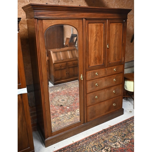 159 - An Edwardian combination wardrobe with mirrored door, smaller cupboard doors and four drawers on pli... 