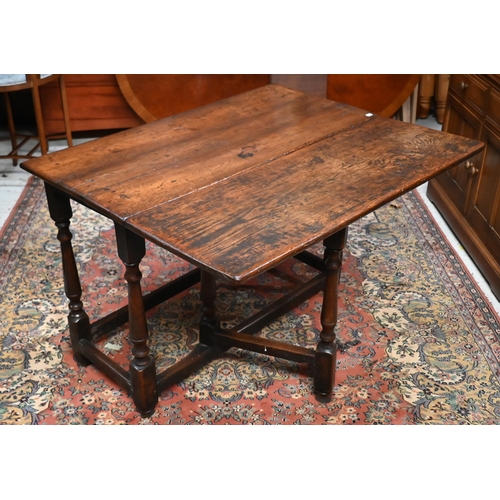 167 - An 18th century oak cottage dining table iwth single-side drop-leaf on gateleg action base, 85 x 105... 