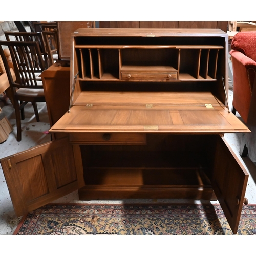 172 - # An Ercol (?) elm fall front bureau with two drawers and panelled cupboards, 94 cm wide x 46 cm dee... 