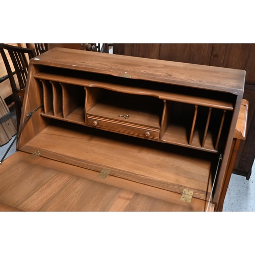 172 - # An Ercol (?) elm fall front bureau with two drawers and panelled cupboards, 94 cm wide x 46 cm dee... 