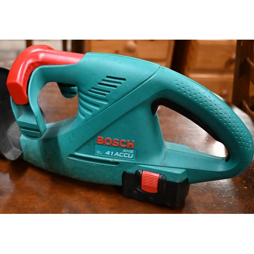 189 - Three small used Bosch electric hedge trimmers, two mains power, one battery c/withy charger and ext... 