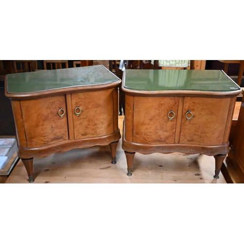 199 - A pair of mid-century burr maple serpentine fronted two door bedside cabinets, with green glass inse... 