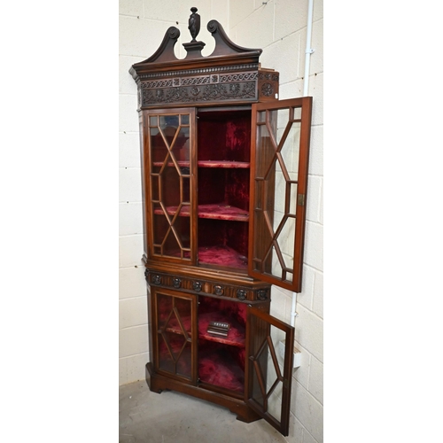 2 - A carved mahogany floor-standing corner cabinet in two parts, with astragal glazed doors and velvet ... 