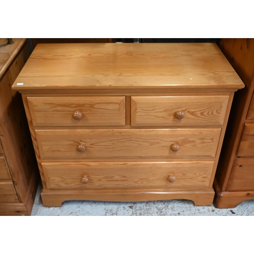 201 - A pair of Ercol pine bedside cabinets to/with a matching chest of two short over two long drawers (3... 