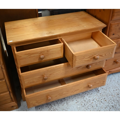 201 - A pair of Ercol pine bedside cabinets to/with a matching chest of two short over two long drawers (3... 