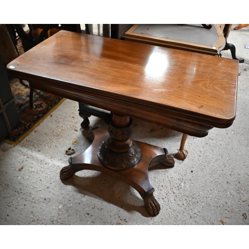 211 - A Victorian mahogany fold over tea table, raised on an acanthus carved support to a platform base, o... 