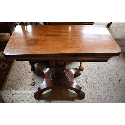 211 - A Victorian mahogany fold over tea table, raised on an acanthus carved support to a platform base, o... 