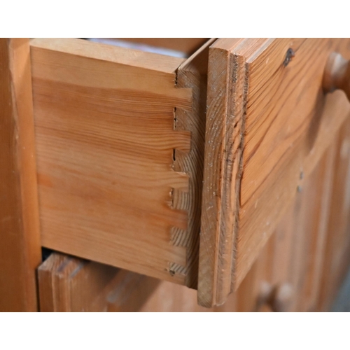 212 - A modern pine cottage dresser, with three drawers over cupboards, 121 cm x 41 cm x 185 cm h