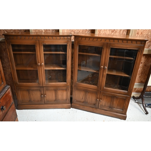 215 - A pair of Ercol part-glazed elm bookcases, each 101 cm w x 31 cm x 138 cm h (2)