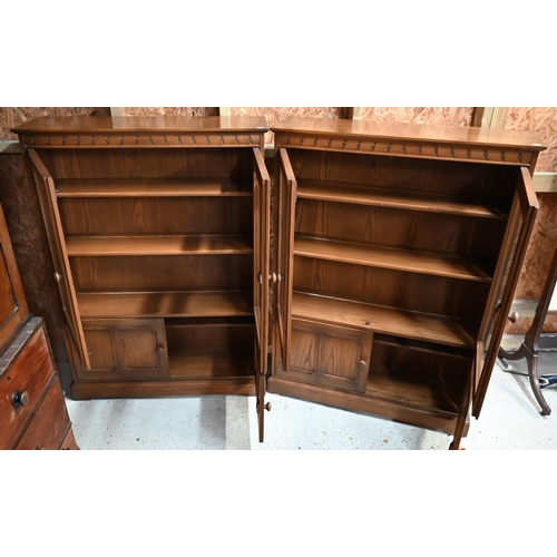 215 - A pair of Ercol part-glazed elm bookcases, each 101 cm w x 31 cm x 138 cm h (2)