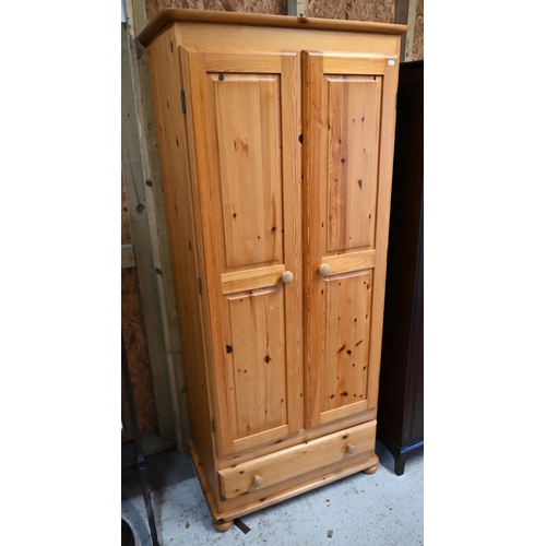 220 - A modern pine two door wardrobe, with drawer to base, raised on bun feet, 81 cm w x 53 cm x 188 cm h