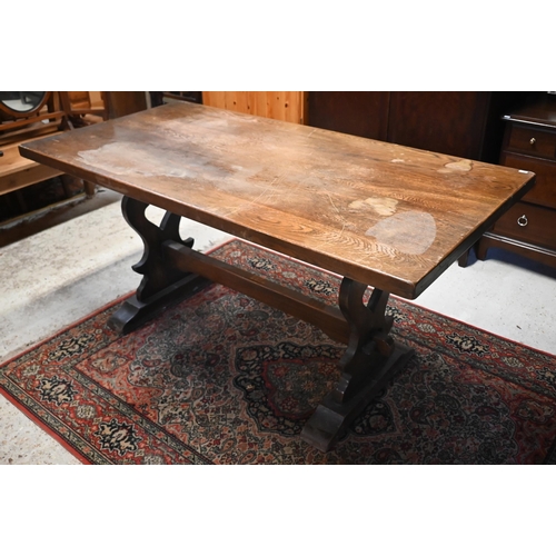 221 - # A traditional elm refectory dining table, raised on shaped trestle ends united by a centre stretch... 