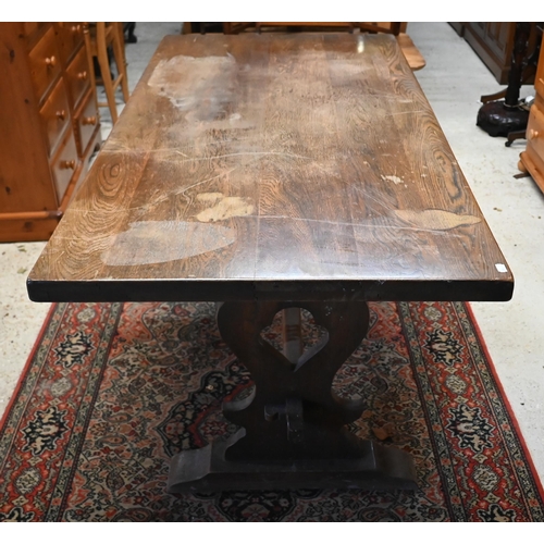 221 - # A traditional elm refectory dining table, raised on shaped trestle ends united by a centre stretch... 