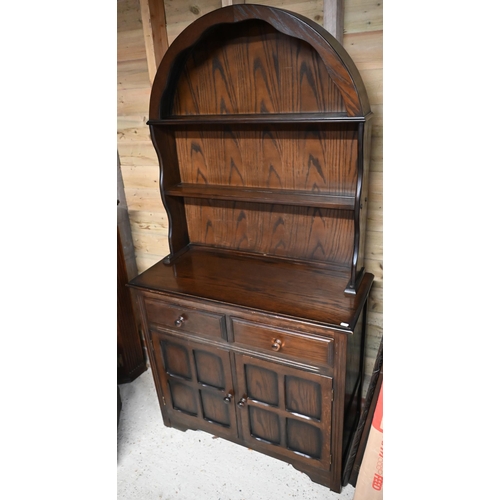 229 - An Ercol style cottage dresser, the domed open rack over two drawers and cupboards, 93 cm w x 40 cm ... 