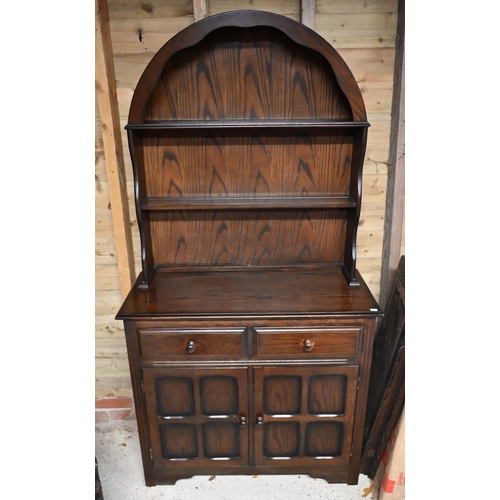 229 - An Ercol style cottage dresser, the domed open rack over two drawers and cupboards, 93 cm w x 40 cm ... 