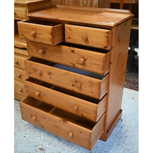 233 - A modern pine tallboy chest of two short over four long graduated drawers, on shaped bracket feet, 9... 