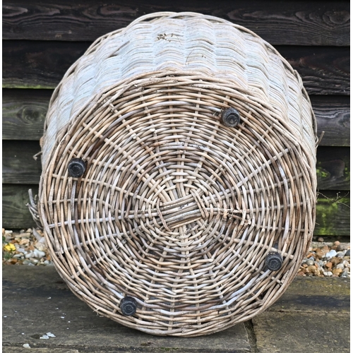 234 - A large contemporary wicker log basket, sacking lined and mounted to castors, 76 cm x 51 cm x 60 cm ... 