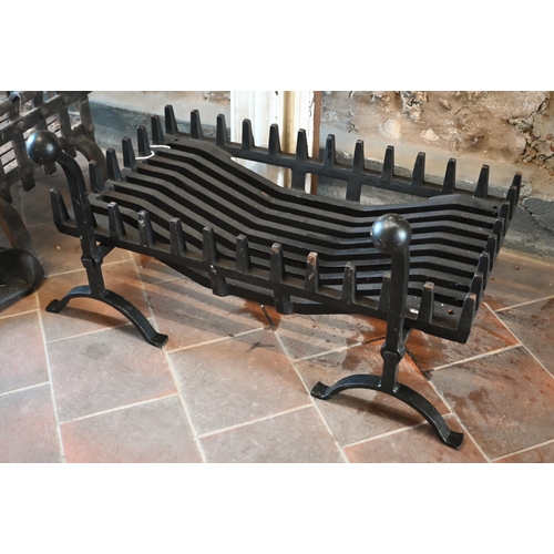 235 - A contemporary traditional cast iron fire basket and dogs to/with another weathered example in the 1... 