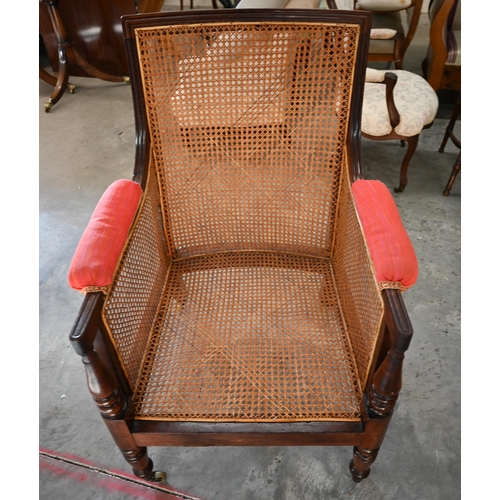 29 - A mid 19th century mahogany framed bergere library chair with baluster turned supports and brass cas... 