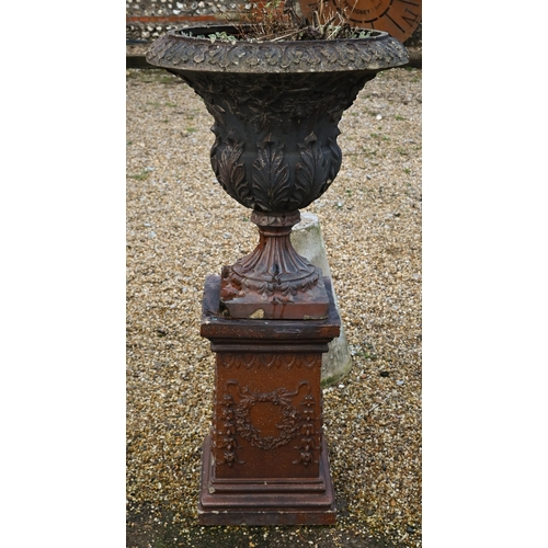 312 - A large weathered classical cast urn on plinth, with patinated stoneware surface finish, on square p... 