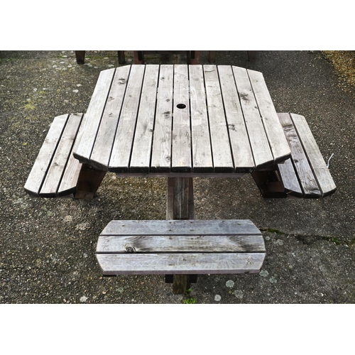 321 - A weathered one piece wooden garden four bench seat picnic table, the table 107 cm x 107 cm x 74 cm ... 