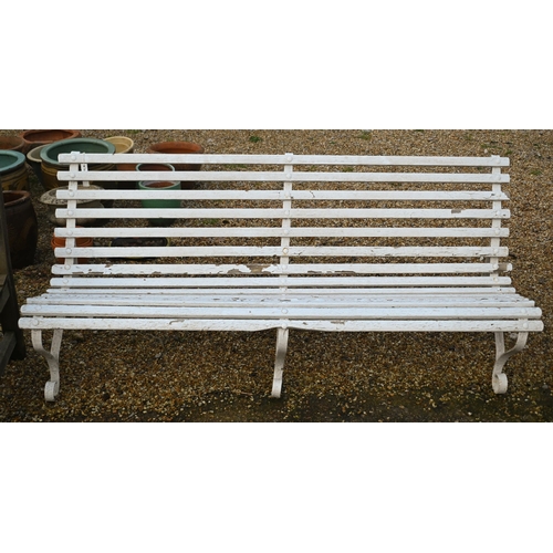 323 - A classic wood-slat garden bench on three wrought steel mounts, painted white, 183 cm long