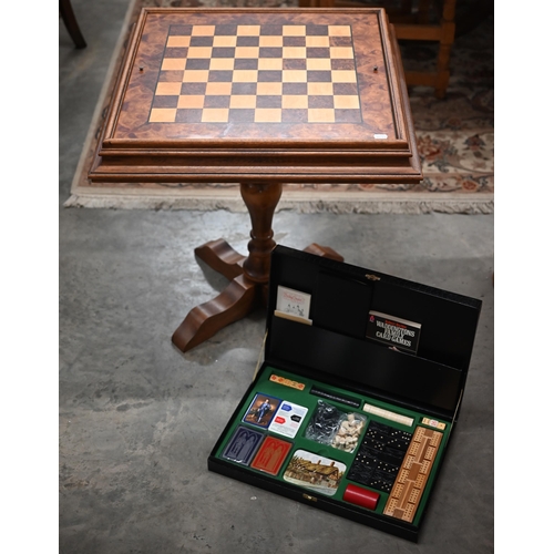 337 - A walnut inlaid games table for chess, cards and backgammon 62 cm square to/w a boxed games compendi... 