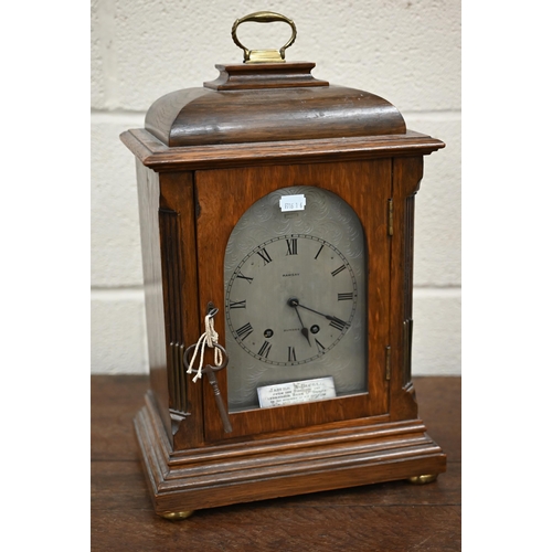 344 - An antique French oak mantel clock with silvered dial inscribed for Ramsay of Dundee, striking on a ... 