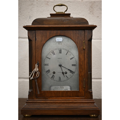 344 - An antique French oak mantel clock with silvered dial inscribed for Ramsay of Dundee, striking on a ... 