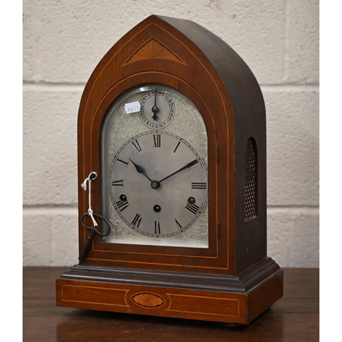 345 - An antique German inlaid mahogany lancet-cased mantel clock with silvered dial, striking and chiming... 