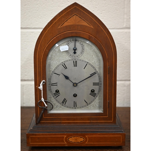 345 - An antique German inlaid mahogany lancet-cased mantel clock with silvered dial, striking and chiming... 