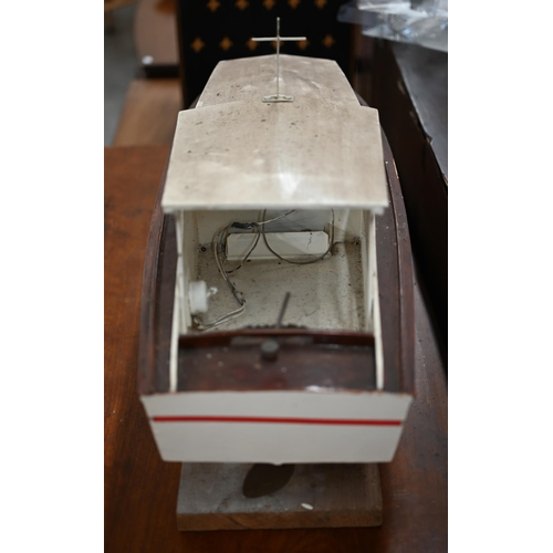 449 - # A painted wood model motor-yacht with electric motor, 75 cm long, on stand