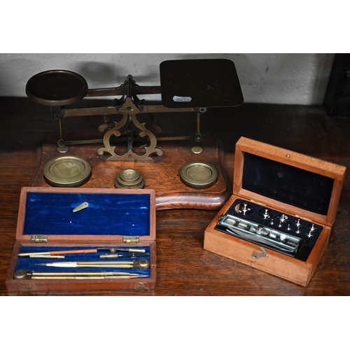 455 - An antique brass set of postage scales with weights on oak base, to/w a boxed set of precision micro... 