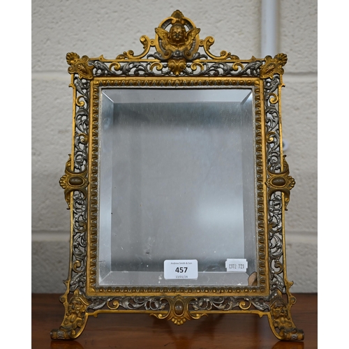 457 - A Continental gilt and silvered brass easel mirror with bevelled plate and ornate pierced frame surm... 