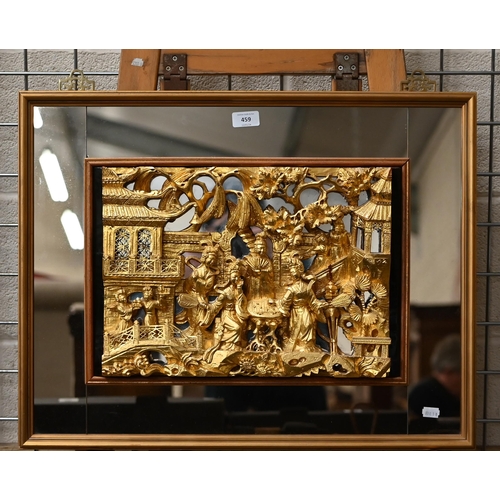 459 - A Chinese carved and gilded relief of noble ladies in a palace garden, in mirrored frame, 52 x 66 cm... 