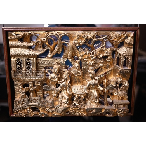 459 - A Chinese carved and gilded relief of noble ladies in a palace garden, in mirrored frame, 52 x 66 cm... 