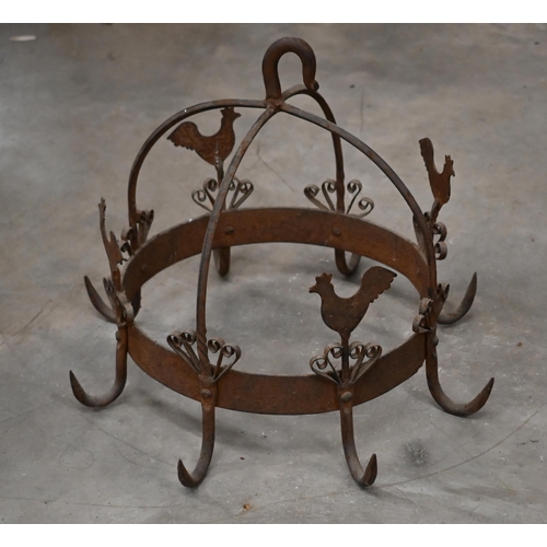 477 - A wrought iron crown-shaped cooking pan rack, embellished with cockerels, 32 cm high x 38 cm diam