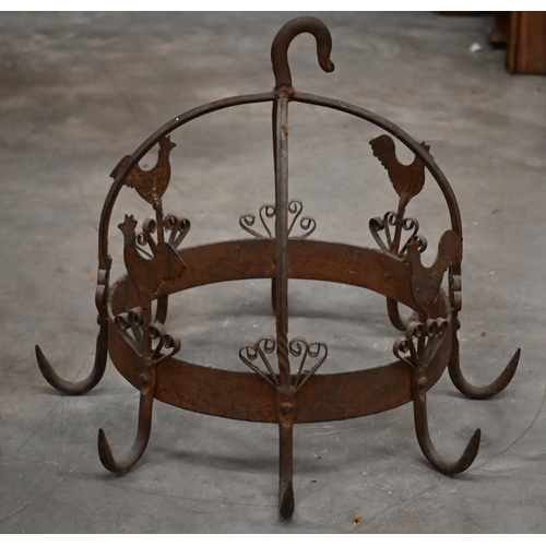 477 - A wrought iron crown-shaped cooking pan rack, embellished with cockerels, 32 cm high x 38 cm diam